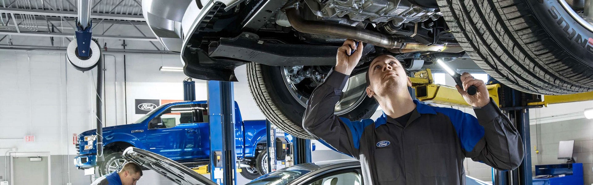 Service mechanic working on a vehicle